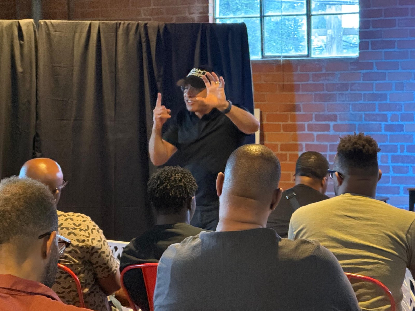 A leader teaching a group of men at an Adam Project gathering